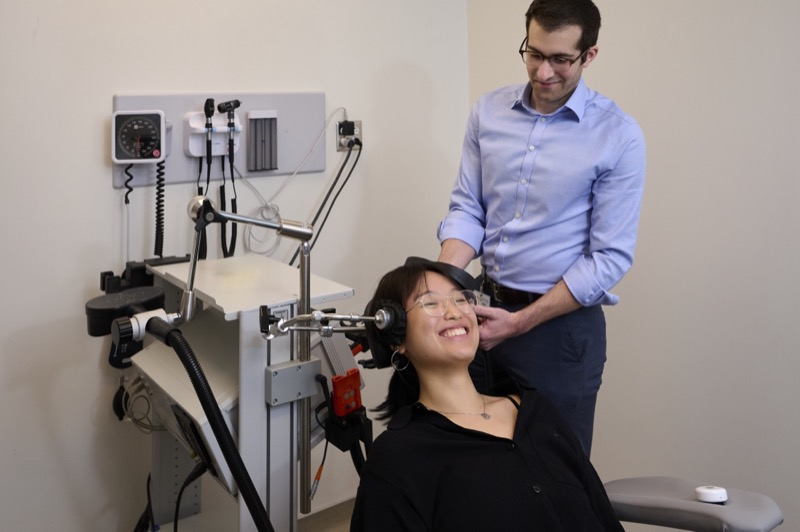 Dr. Aaron Slan checking a motor threshold during TMS treatment calibration at UCLA