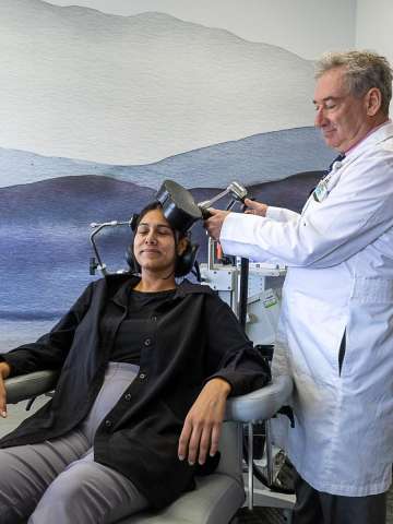 Psychiatrist administering TMS treatment to a patient